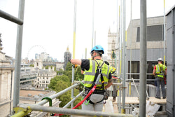 Man working on scaffold site wearing scaffold harness
