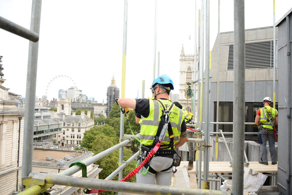 Man working on scaffold site wearing scaffold harness