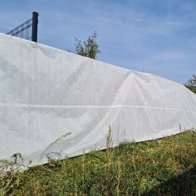 Vented scaffold sheeting installed on a fence