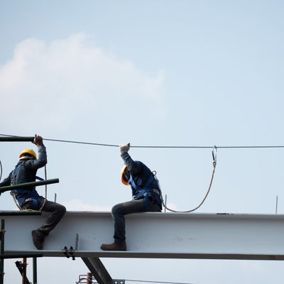 Two workers sitting on a beam using BIGBEN® Galvanised Wire Rope Temporary Lifeline