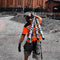 Worker wearing scaffshirt carrying heavy poles